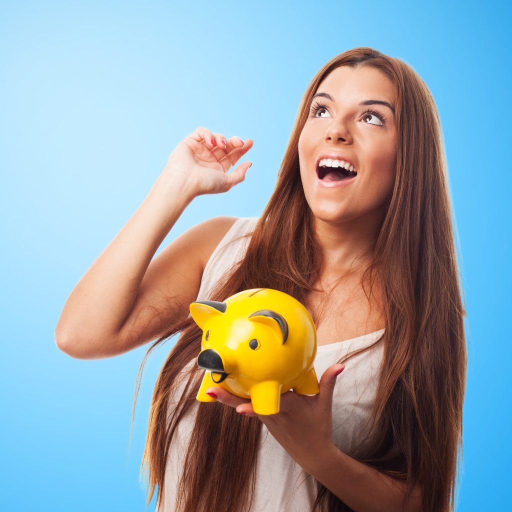 young woman thinking about the future holding a piggy bank